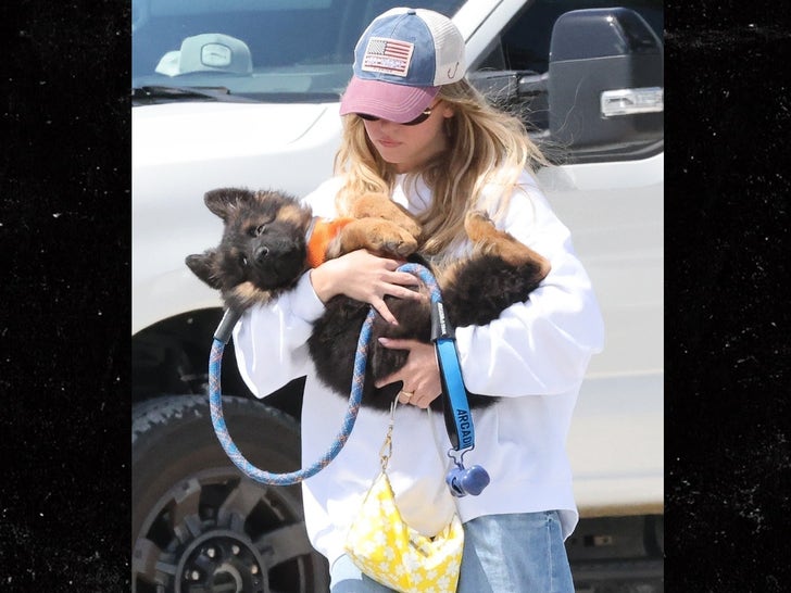 0422-Sydney-Sweeney-And-Jonathan-Davino-Walk-Together-While-Holding-A-New-Puppy-primary-3