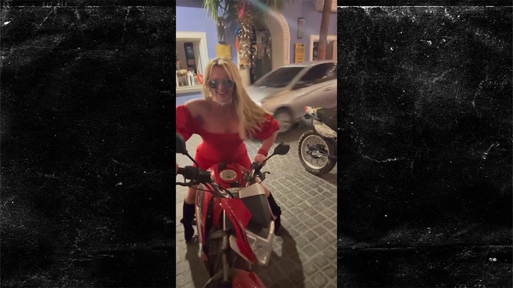 Britney Spears Hops on Back of Motorcycle in Bright Red Dress britney-spears-motorcycle-kal-04-26-2025