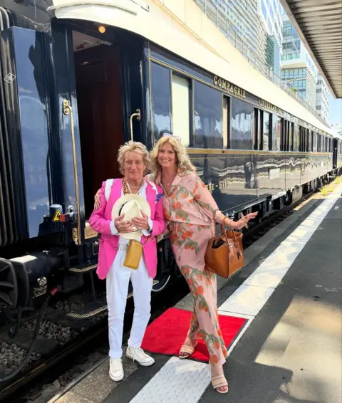 'I wish they wouldn't call it the tea time slot' Instagram Penny Lancaster hugs her husband Rod Stewart, as they pose outside the Orient Express at a train station.