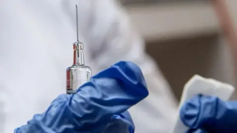 Briton dies from rabies after stray dog contact in Morocco Getty Images A needle in the hands of a medic, with blue gloves in shot.