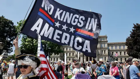 Mass protests against Trump across US as president holds huge military parade Getty Images People take part in a "No Kings" protest outside the Michigan Capitol in Lansing, Michigan, on 14 June 2025 as US President Donald Trump presides over a military parade in Washington, DC.