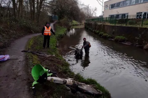 Lime bikes dumped in canals and rivers 'posing pollution risk' Little Litter Pickers of Nottingham Ethan Radford standing in the River Leen with a Lime bike in the foreground