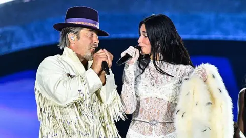 Dua Lipa brings out Jamiroquai at emotional Wembley debut Getty Images Jay Kay of Jamiroquai sings with Dua Lipa at Wembley Stadium
