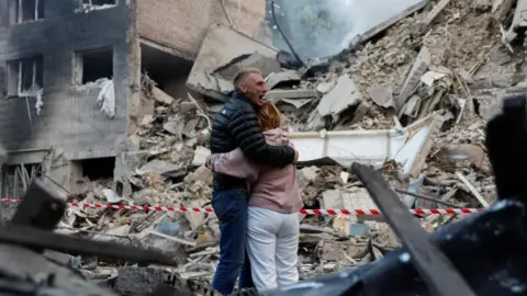 At least 14 killed and dozens injured in Russian strike on Kyiv Reuters Residents react at the site of an apartment building damaged during a Russian strike on Kyiv.