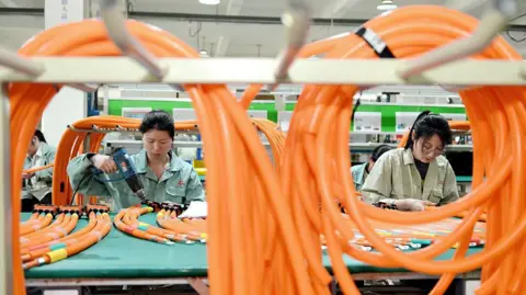 How China made electric vehicles mainstream Getty Images Workers manufacture high-voltage wiring harness products for new energy vehicles in the workshop in Nantong City, Jiangsu Province, China, on May 13, 2025.
