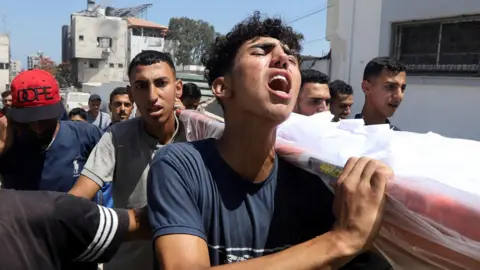 Hamas official says Gaza mediators intensifying ceasefire efforts Reuters Mourners react during the funeral of Palestinians reportedly killed in an Israeli air strike, at al-Shifa hospital, in Gaza City (25 June 2025)