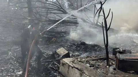 What we know so far after Air India flight from Ahmedabad to London Gatwick crashes AP Firefighters tackle debris after plane crash