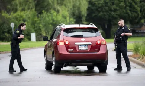Minnesota lawmakers Melissa Hortman and John Hoffman targeted by gunman, suspect at large Getty Images Police ask a driver some questions