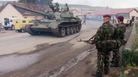 A Belgrade landmark bombed by Nato could get Trump makeover Getty Images A Serbian tank and its crew drive past standing British soldiers in Kosovo