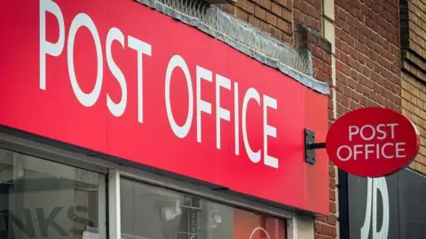 Insufficient action on compensation, say MPs Getty Images The front of a Post Office branch on a High Street