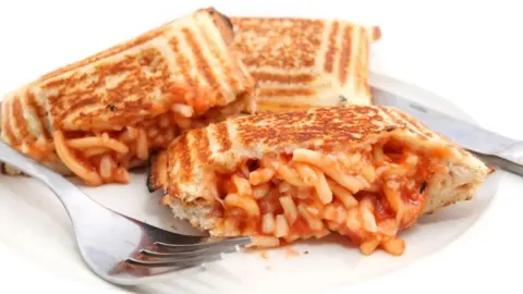 Japanese fruit sando hits high streets Kai_Wong/Getty Images Three toasties made with spaghetti in tomato sauce are on a white plate, with some of the spaghetti oozing out of them