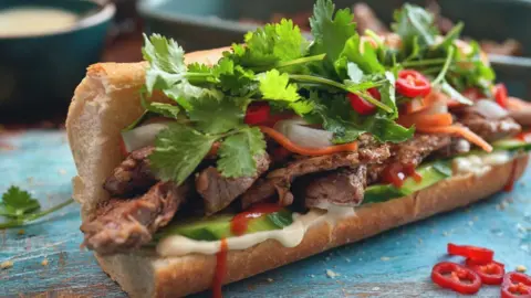 Japanese fruit sando hits high streets GMVozd/Getty Images A bánh mì, covered in coriander and served alongside slices of chilli, is shown on a table