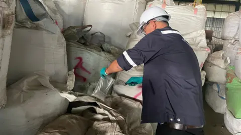 Why your old mobile phone may be polluting Thailand An Inspector take samples of electronic waste