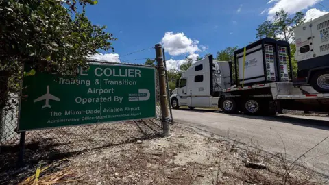 The abandoned Florida airport being turned into 'Alligator Alcatraz' Getty Images/Miami Herald A truck carrying generators drives past a sign saying 'Collier'