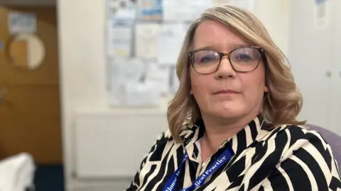 Behind the scenes at a GP 8am scramble Tricia Gibbons is the manager of the Tudor House Medical Centre in Nottingham and is sat behind the main reception area.