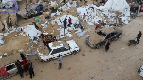 At least 81 people killed in Israeli strikes in Gaza, Hamas-run health ministry says Reuters Three cars and multiple tents and people's belongings buried in the sand following a strike