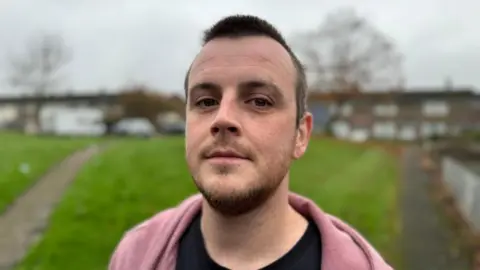 What's behind the mis-selling complaints? Marcus Johnson Marcus Johnson, 34, from Cwmbran, Torfaen, stands in front of some houses and a green.