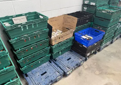 Lincoln food bank at 'breaking point' due to low stock BBC News The photo shows towers of crates piled on top of one another. In them are tinned items, and there are signs indicating the content of them. One reads 'stodgy meals' and another reads 'meatballs and chilli and hot dogs.'