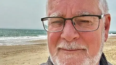 Reactions to winter fuel payment U-turn Ian Bryant Ian is pictured in a selfie on the beach with a neutral expression