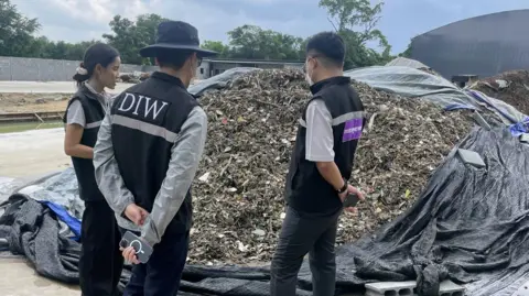Why your old mobile phone may be polluting Thailand BBC Inspectors from Thailand’s industry ministry survey a pile of electronic waste during a raid of an unlicenced recycling plant in eastern Thailand