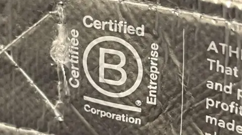 The global environmental award hit by accusations of greenwashing Getty Images Close up of the B Corp logo on a bag from US brand Athleta