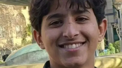 Two charged with murder in Sheffield after boy killed by car South Yorkshire Police Abdullah looks into the camera with a smile showing his teeth. He has short dark hair.