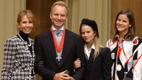 Governments have neglected the North East for decades PA Sting's wife Trudie Styler in black and white checked jacket, Sting in dark suit with CBE around his neck and his daughter Coco in black jacked and Kate in white, red and black geometric shirt, at Buckingham Palace, which he received for services to the music industry. "I'm surprised and flattered to receive this honour," he said recently. "If my mum and dad were still here they would be made up."