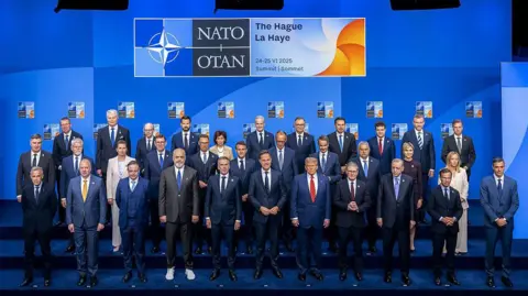 Nato agrees spike in defence spending and stresses 'ironclad' security guarantee AFP Nato family photo