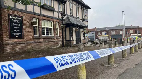 Teens arrested on suspicion of murder as boy, 14, stabbed to death Police tape cordoning off the Fairway Inn pub in New Moston.