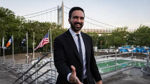 Zohran Mamdani stuns Andrew Cuomo in NYC mayor primary Getty Images Zohran Mamdani reaches out his hand. He is wearing a suit. A bridge can be seen behind him, along with flags