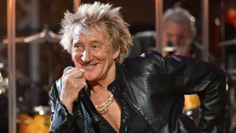'I wish they wouldn't call it the tea time slot' Mark Allan / BBC Rod Stewart, dressed in black leather, smiles as he leans on a piano top, during a recording of the BBC's Later... With Jools Holland