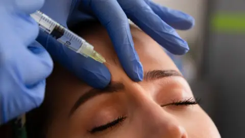 Warning over fillers and botox being offered in public toilets Getty Images A woman has a substance injected between her eyebrows