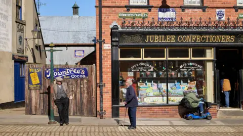 Open-air attraction in County Durham wins Museum of the Year David Levene A street scene at Beamish open-air museum in Country Durham, showing men standing outside a confectioners