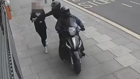 Apple and Google clash with police and MPs over phone thefts Metropolitan Police A person on a moped snatching a phone out of the hands of a member of the public