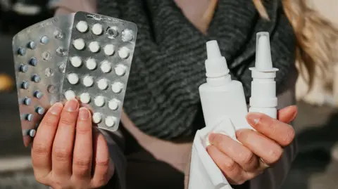 Why is my hay fever so bad this year? Getty Images A woman holds up two packs of antihistamine pills in one hand and nasal and eye sprays on in the other, along with a tissue