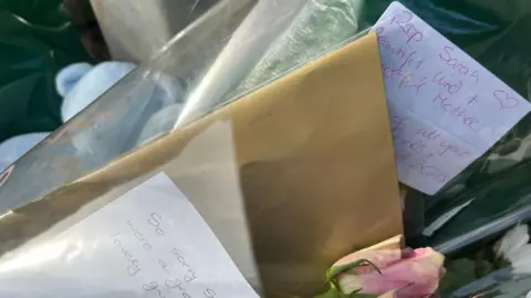 Second arrest in Donaghadee murder inquiry A close up of some of the handwritten tributes, teddies and flowers laid near the police cordon. One of the notes reads: RIP Sarah – beautiful, kind and wonderful mother.