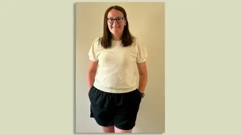 Wearing shorts still a 'grey area' as offices scrap dress codes Diane Brander A woman with brown hair and glasses is smiling. She is wearing a white t-shirt and black shorts
