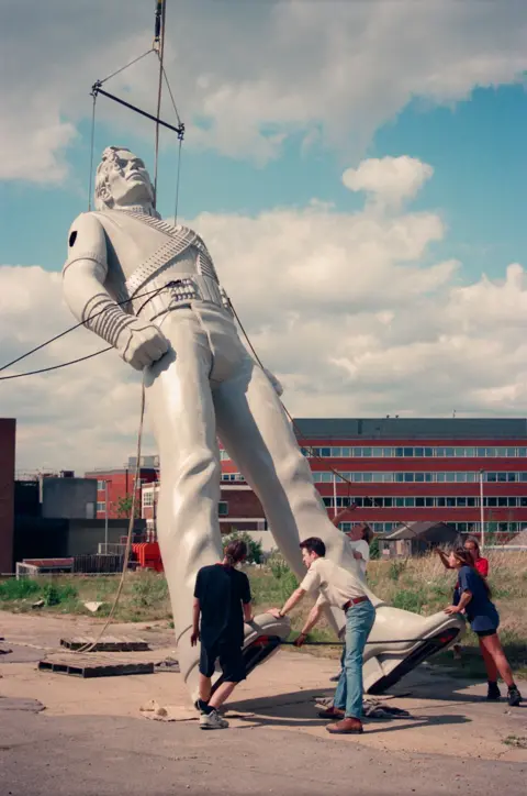 Where are Michael Jackson's giant HIStory statues 30 years later? Stephen Pyle An old photo shows a large Michael Jackson statue is being hoisted on to its feet by people pulling on ropes.