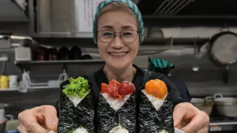 How a joke about rice cost a Japan cabinet minister his job Getty Images Owner of Onigiri Bongo, a shop specialising in rice balls known as "onigiri"
