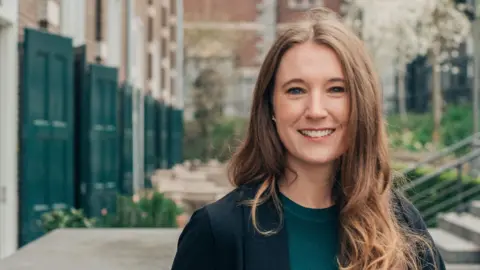 Why we need 'revolutionary' cooling tech Tati van Thiel Photography A smiling Lindsay Rasmussen stands outside.