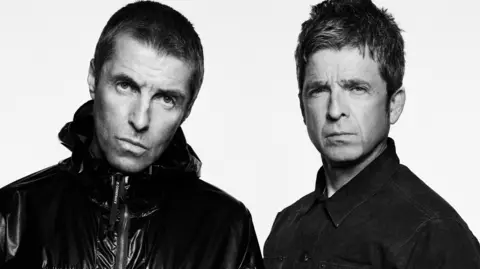 Aldi in Oasis rebrand as homage to band ahead of Manchester gigs PA Media A black and white image of Liam and Noel Gallagher. Liam has closely cropped hair and wears a zipped up jacket and Noel has short hair and wars a denim jacket