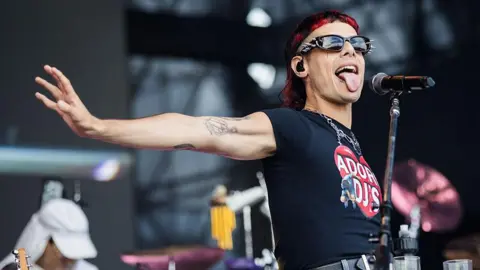Five newcomers you don't want to miss Getty Images Catriel Guerreiro, of the Argentinian band Ca7riel and Paco Amoroso, sticks his tongue out while performing on stage in Brazil