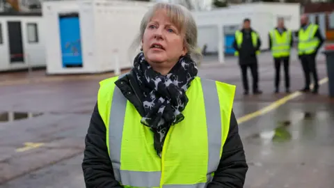 Shaping Scotland's priorities for years to come PA Media Shona Robison in a green hi-vis tabard and outdoor clothing is standing in an industrial setting. Some men in the same stand behind her.