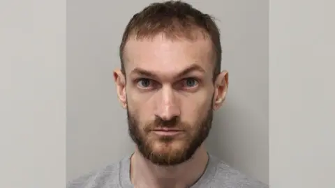 Man guilty of murdering schoolboy in Hainault Met Police Custody mugshot of Marcus Monzo wearing a grey top