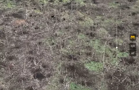 A Russian soldier takes the stand for an execution A drone view of the area of the frontline assaulted by Kurashov and his unit, in the eastern oblast of Zaporizhzhia.