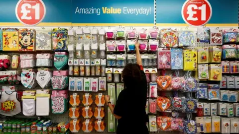 'I was Mrs Poundland, but I stopped going when their prices went up' Reuters A woman stands in front of a display of baby and party products at Poundland.