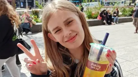 'Missed opportunities' in terror suspect Rhianan Rudd's death Family handout Picture of Rhianan smiling at the camera. She has blonde hair and is wearing a red shirt.
