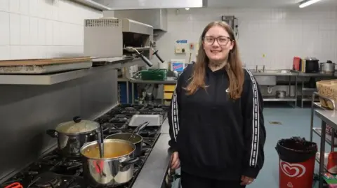 North Shields social hub helps care-experienced people gain skills North Tyneside Council Rachel Fairless is standing smiling in the kitchen beside a big pot on a large hob. She is wearing a black top, glasses and has long fair hair.