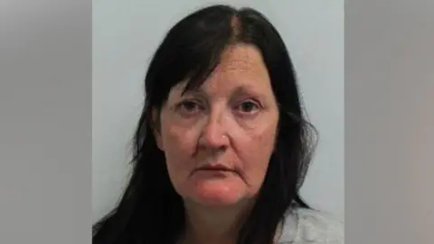 Wandsworth neighbour jailed for doorbell camera abuse and threats Metropolitan Police A police mug shot of Drina Gray, a woman with long dark hair