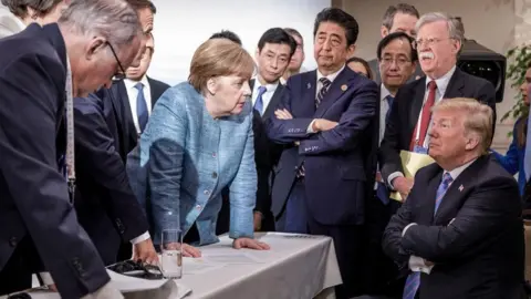 G7 is a big moment for Carney. Here are five things to watch Bundesregierung/EPA A handout photo made available by the German Government (Bundesregierung) on 09 June 2018 shows French President Emmanuel Macron (3-L, partially hidden), German Chancellor Angela Merkel (C-L) and Japan"s Prime Minister Shinzo Abe (C-R) speaking to US Presidend Donald J. Trump (R, seated) during the second day of the G7 meeting in Charlevoix, Canada